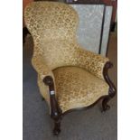 A Victorian Mahogany Framed Armchair, Having a serpentine front, with later floral upholstery,