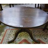 A Georgian Oak Supper Table, The circular top is raised on tripod supports, been cut to size, 54cm