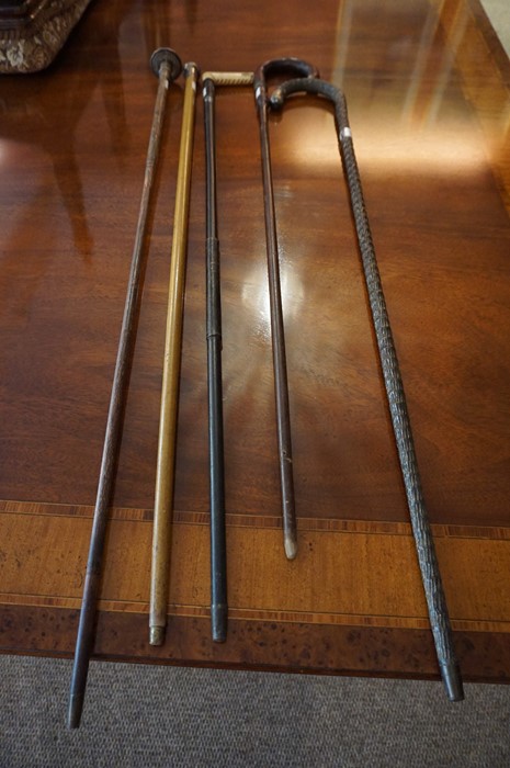 Five Assorted Walking Sticks, circa early 20th century, to include two with silver tops and two with