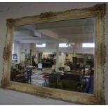 A Large Bevelled Glass Wall Mirror, Having a gilt and ivory coloured frame, 96cm high, 127cm wide