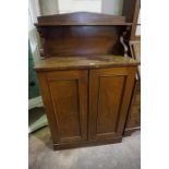 A Victorian Mahogany Chiffonier, Of small proportions, Having a shelved top, above a cupboard