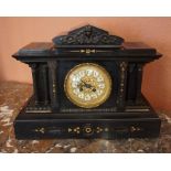 A Victorian Black Slate Mantel Clock, Having an ormolu decorated dial, with mask panels, stamped