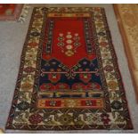An Old Turkish Ladick Rug, Decorated with floral and geometric motifs, on a red ground and beige