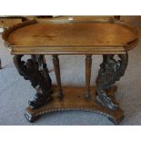 A Victorian Carved Oak Silver Table, Having a shaped top, raised on four carved dolphin columns, and