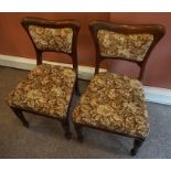 A Set of Six Victorian Mahogany Dining Chairs, Having a curved rail above later floral upholstery,