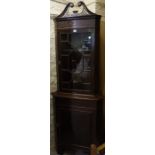 A Mahogany Corner Cabinet, circa late 19th / early 20th century, Having a carved scroll pediment,