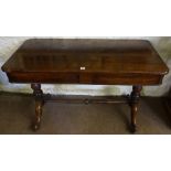 A Victorian Rosewood Library Table, Having a plain rectangular top with canted corners, raised on