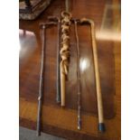 Five Assorted Walking Sticks, To include a carved dragon head example, a stick carved with