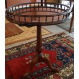 A Georgian Style Tripod Table, 20th century, Having a circular gallery top, raised on a reeded