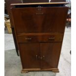 An Art Deco Mahogany Fitted Cocktail Cabinet, circa 1930s, Having a fall front, enclosing a fitted