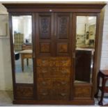 A Late Victorian Walnut Wardrobe, Having two cupboard doors above four drawers, flanked with a