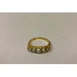 A Ladies 18ct Gold Pearl Ring, Set with five graduated pearls, stamped 18, hallmarks for Birmingham,
