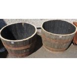 A Pair of Wooden and Metal Bound Half Barrels, 45cm high, 65cm wide, (2)