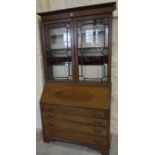 A Mahogany Inlaid Bureau Bookcase, Having two astragal doors enclosing a shelved interior, above a