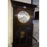 A Mahogany Wall Clock, circa 1920s, having a silvered dial, with pendulum and key, 64cm high