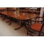 A Regency Style Mahogany Triple Pillar Dining Table, Having three additional leaves, raised on