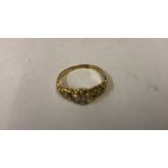 An 18ct Gold Seed Pearl and Diamond Ring, Set with a small diamond to the centre, interspersed by