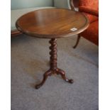 A Victorian Mahogany Tea Table, Having a circular top, raised on a barley twist column and tripod