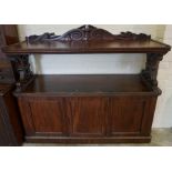 A Victorian Mahogany Buffet Cabinet, Having a rectangular top, raised on carved supports, above an