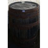 A Wooden and Metal Bound Whisky Barrel, 88cm high, 50cm wide