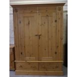 A Pine Wardrobe, Having two doors above two drawers, 200cm high, 148cm wide, 55cm deep, also with