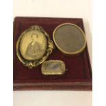 A Victorian Portrait Mourning Brooch, Having a revolving central portrait locket, with platted