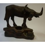 A Carved Hardwood Figure / Desk Stand, Modelled as a Water Buffalo, 20th century, 25cm high