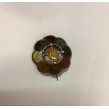A Scottish Unmarked Silver and Agate Brooch, Set with a 1.5cm citrine cabochon to the centre, in a