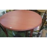 An Antique French Red Painted Circular Table, raised on turned legs, with brass castors, 74cm