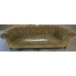 A Chesterfield Three Seater Sofa, Uphostered in yellow fabric, decorated with allover blue floral