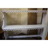 A Set of White Painted Hanging Wall Shelves, Having five pegs to the lower shelve for hat and coats,
