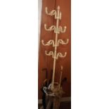 An Antique French Painted Cast Iron Hat and Coat Stand, having eight scroll pegs, drip tray base,