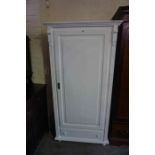 A Modern White Painted Pine Wardrobe, Having a panelled door, enclosing a hanging rail, above a