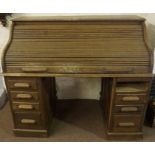 A Lebus Oak Roll Top Desk, circa 1930s, Having a tambour shutter enclosing a fitted interior, raised