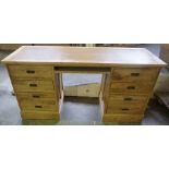 A Modern Light Oak Kneehole Desk, Having a pull out slide, flanked with four drawers, 81cm high,