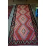 An Antique Iranian Kelim Rug, Decorated with multiple geometric panels, on a multi coloured