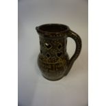 A Treacle Glazed Terracotta Puzzle Jug, circa late 19th / early 20th century, having motto to the