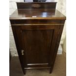 A Mahogany Bedside Cupboard, Having a panelled door, enclosing a shelved interior, 100cm high,