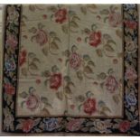 An Old English Style Needlepoint Rug, Decorated with allover floral panels, on a beige ground with