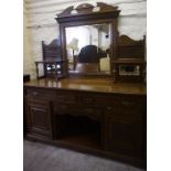 A Late Victorian Oak Mirror Back Sideboard, The mirrored section is raised on turned pilasters,