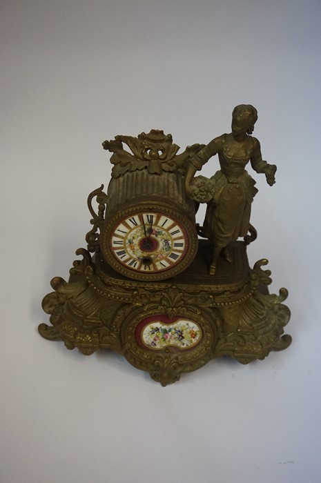 A French Gilt Metal Mantel Clock, circa late 19th century, Decorated with a standing maid next to