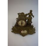 A French Gilt Metal Mantel Clock, circa late 19th century, Decorated with a standing maid next to