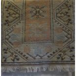 A Turkish Rug, Decorated with geometric and floral motifs, on a cream and pink ground, 150cm x 80cm