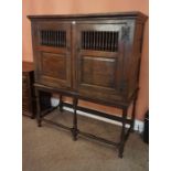 An Oak Dole Cupboard on Stand, circa 17th century and later, Having two balustrade decorated