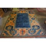 A Yagcibedir (Turkish) Rug, Decorated with geometric medallions, on an orange and blue ground,