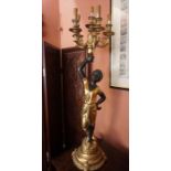 An Italian Style Gilded Floor Standing Candleabra, 20th century, Modelled as a Blackamoor child
