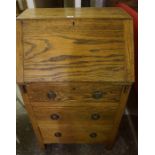 A Vintage Ladies Oak Writing Bureau, Having a fall front, enclosing fitted pigeon holes, above three