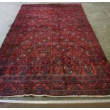 A Turkoman Rug, Decorated with allover geometric motifs, on a red ground, 280cm x 180cm