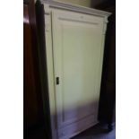 A Modern White Painted Pine Wardrobe, Having a panelled door, enclosing a hanging rail, above a