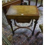 A Victorian Walnut Work Table, Having a hinged top, enclosing fitted compartments, above under